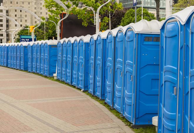 a row of portable restrooms set up for a large athletic event, allowing participants and spectators to easily take care of their needs in Riverside UT